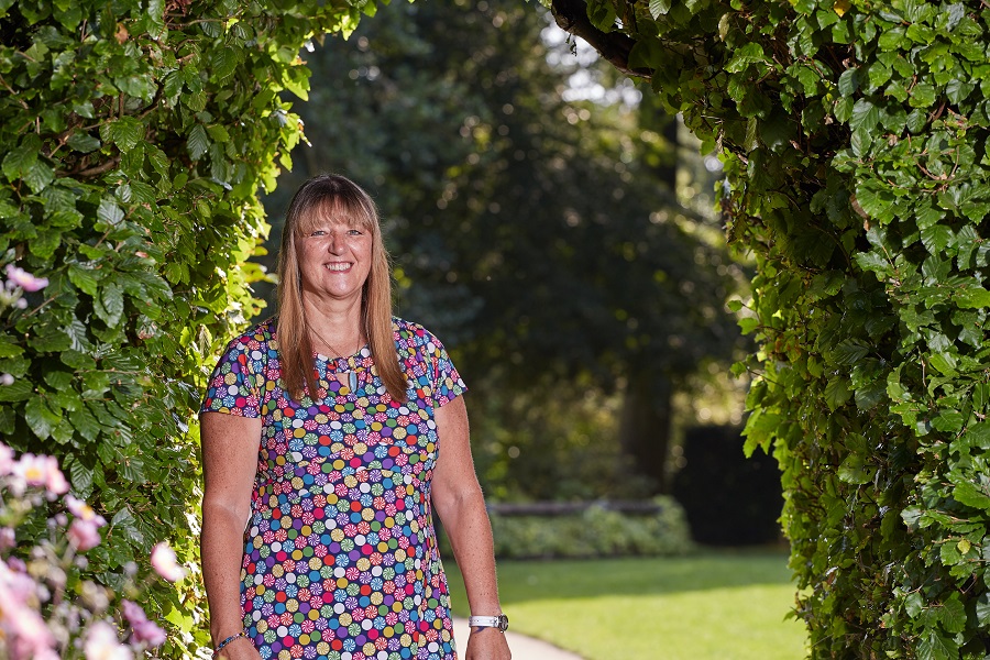 WI Member Wendy Morris standing in a garden