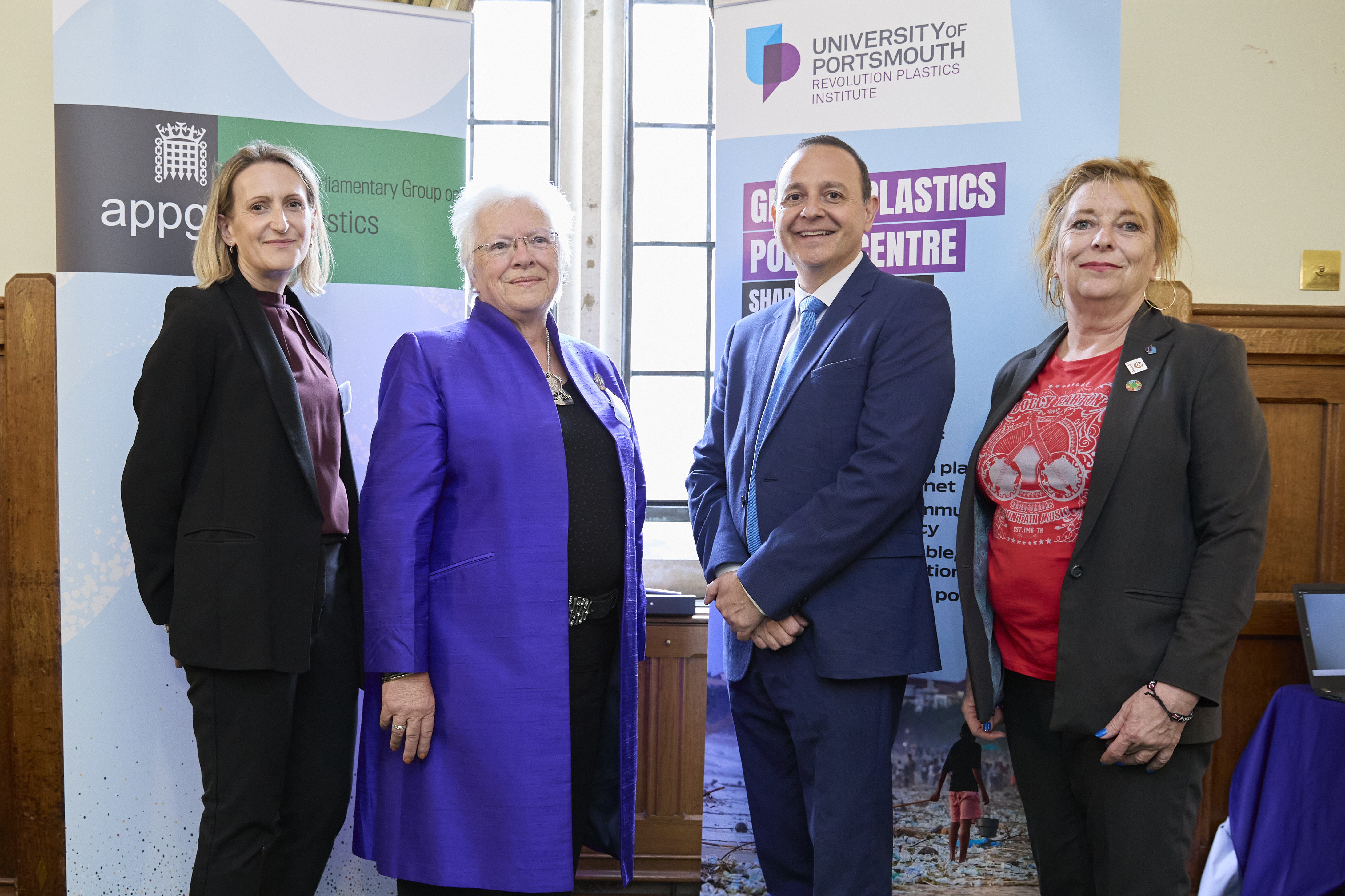 Four people stood in front of APPG on microplastics sign
