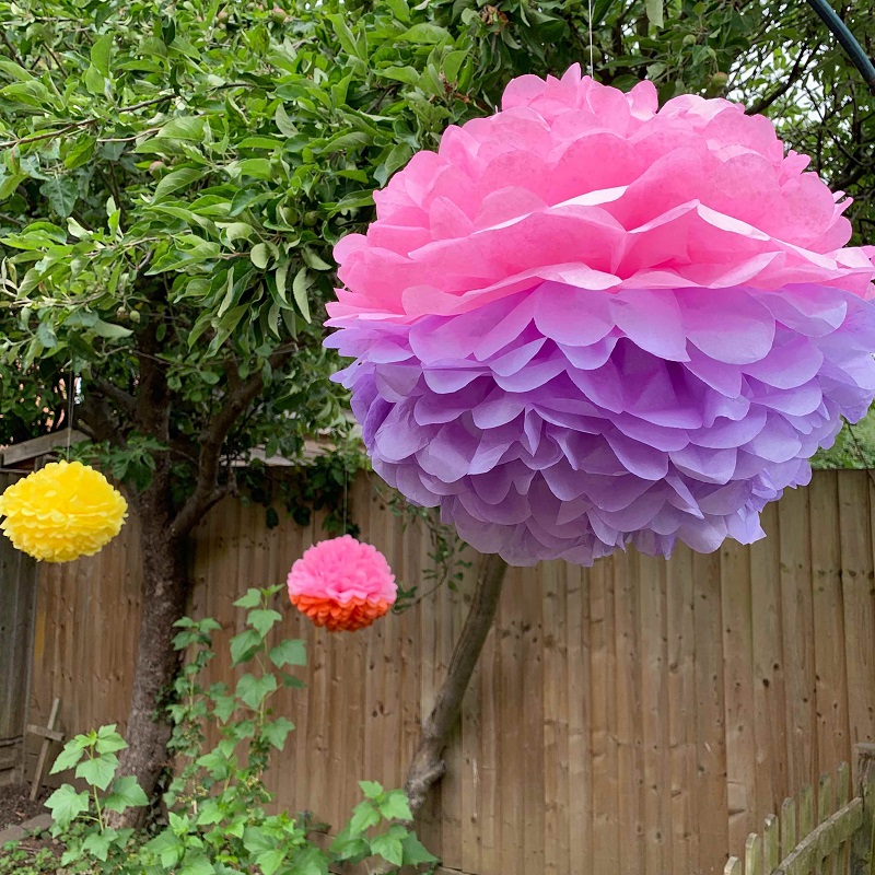 A large pink and purple paper pompom