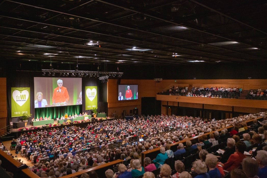 NFWI Chair Lynne Stubbings giving a speech to a big audience of WI members at the AM 2019