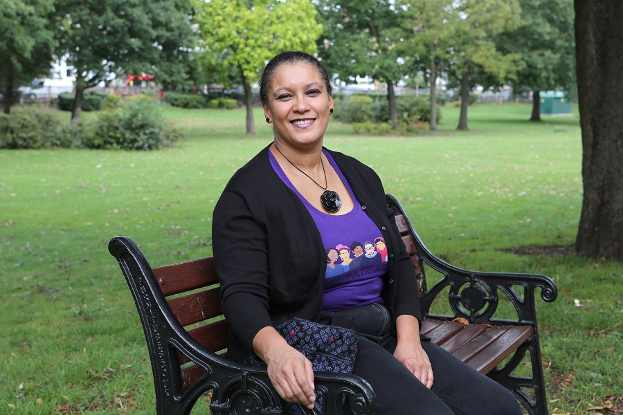 WI Member Yvette sitting on a bench in a park