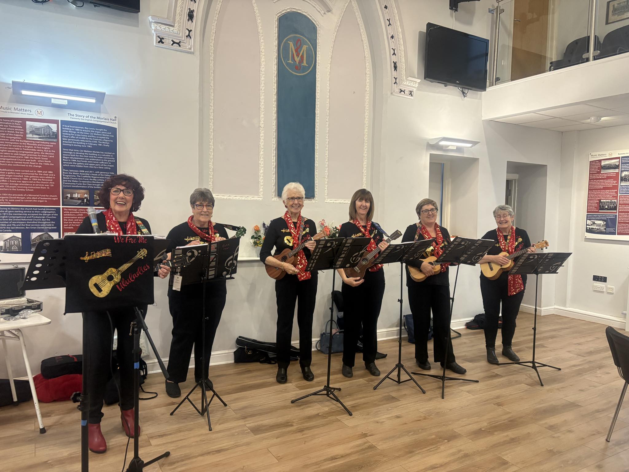 6 WI members standing with ukuleles smiling