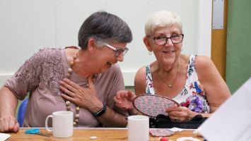 Members crafting and laughing at a WI meeting