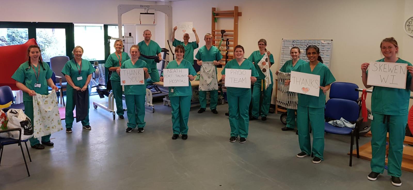 A group of physiotherapists in green scrubs