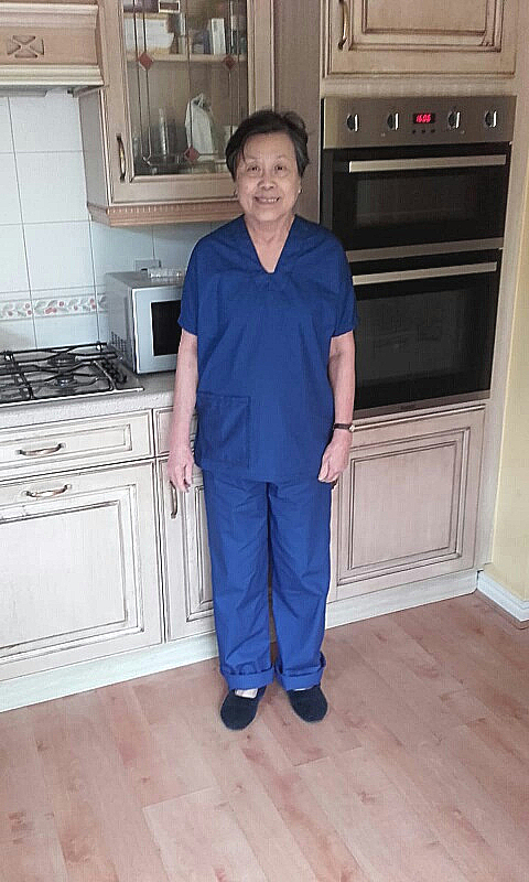 A woman wearing blue scrubs