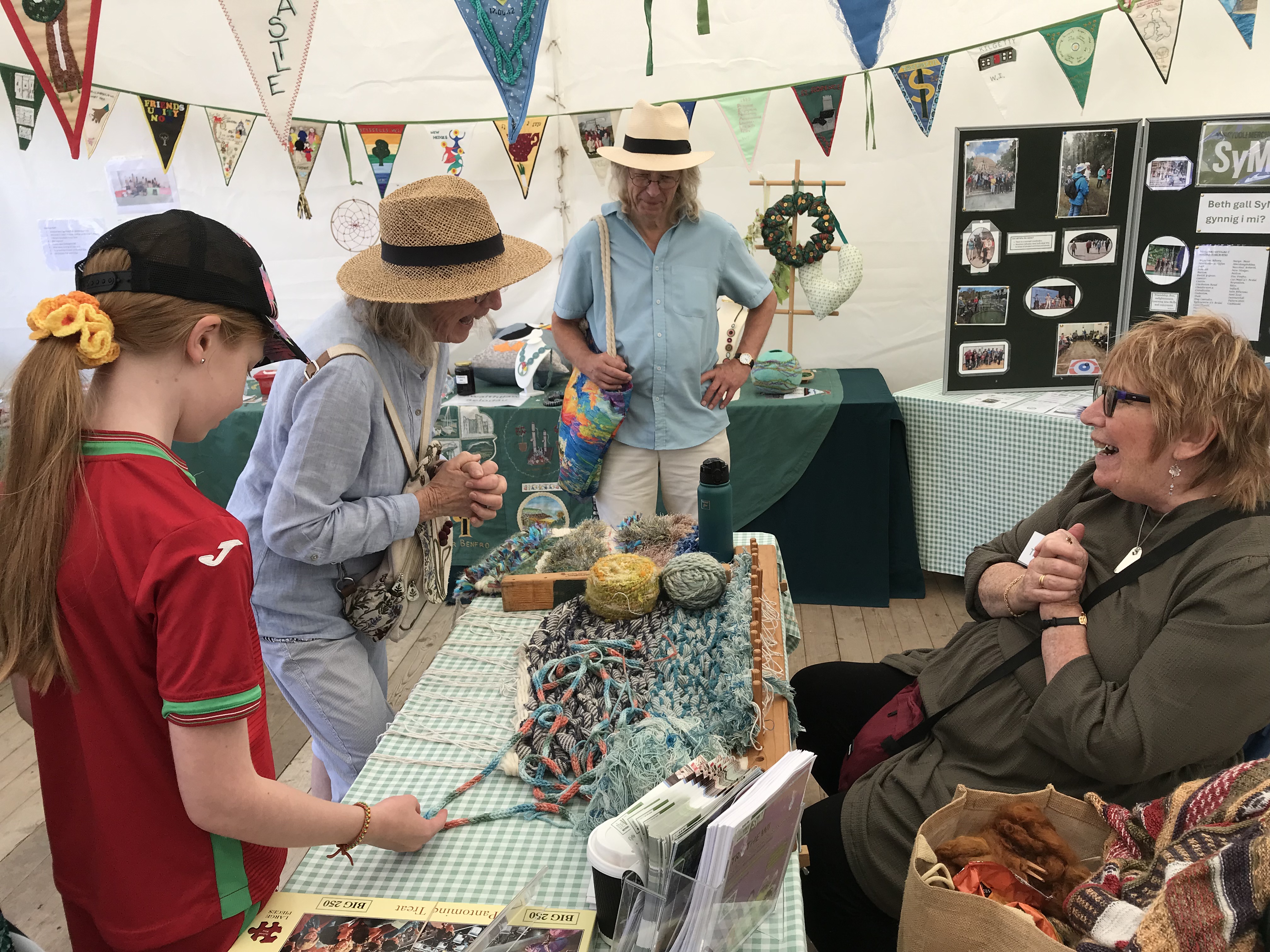 Several people discussing wool over a table