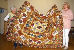 Jenny Lester and Myra Taylor with a quilt