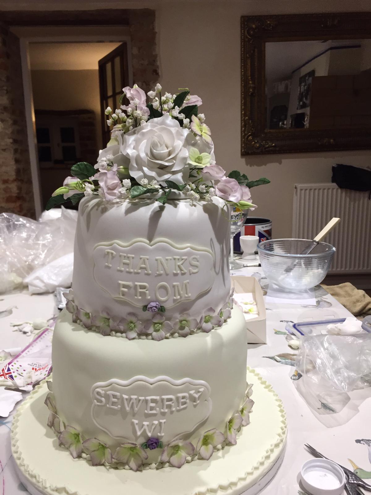 White two tier cake with flower decoration