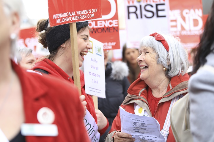 Two women talking and laughing at the Million Women Rise march