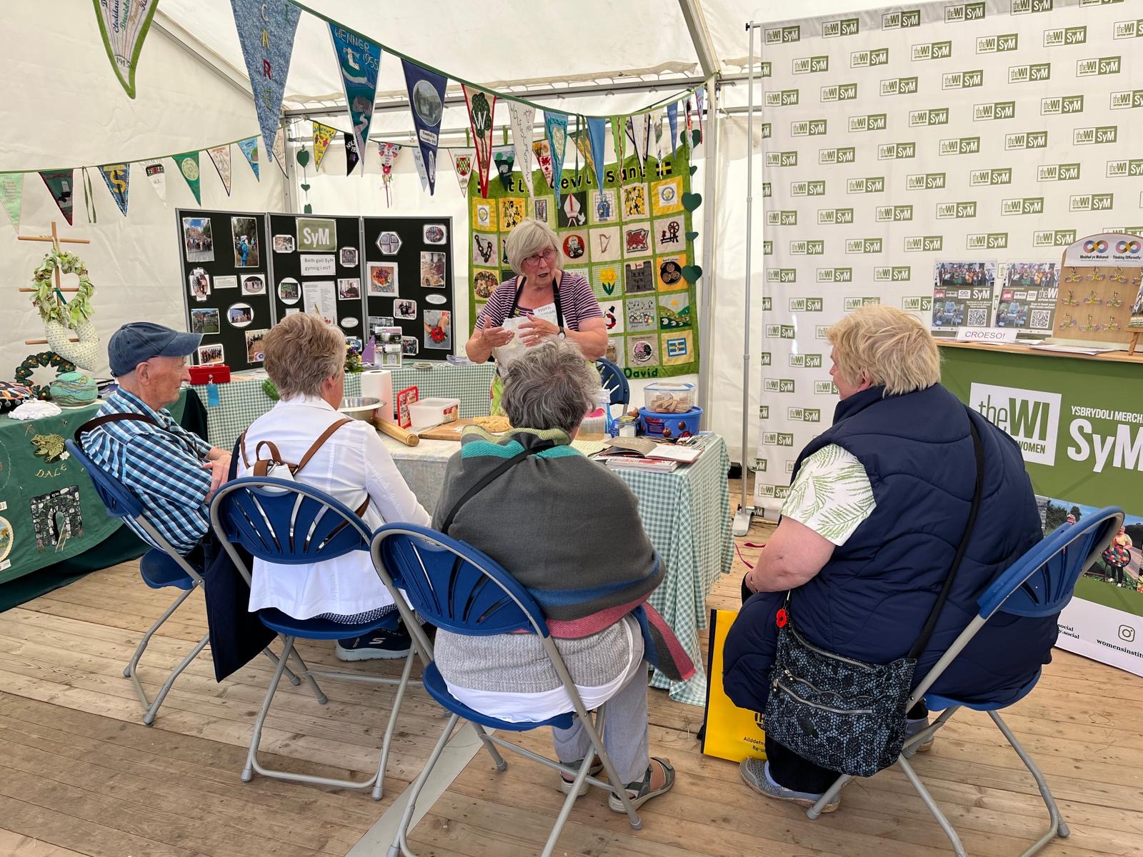 A cookery demonstration with several people watching