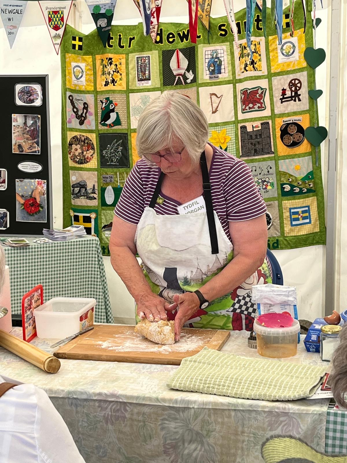 A cookery demonstration of someone kneading dough