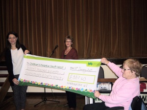 Kylie receiving cheque from Patsy and Chris