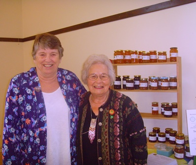 Sue Kendall, County Chairman, with Jackie Gregory of ACWW with some of the jams she has made to raise funds for ACWW
