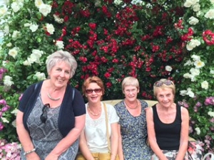 Group with bank of flowers
